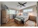 This bedroom features a ceiling fan, hardwood floors, and plenty of natural light at 4224 Firwood Ln, Charlotte, NC 28209