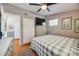 Comfortable bedroom showcasing a plaid bedspread, ceiling fan, and neutral wall color at 4224 Firwood Ln, Charlotte, NC 28209