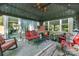 Relaxing covered patio with comfortable seating, ceiling fans, and decorative accents for outdoor enjoyment at 4224 Firwood Ln, Charlotte, NC 28209