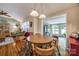 Cozy dining area featuring a round wooden table, hardwood floors, and an open view to the sunroom at 4224 Firwood Ln, Charlotte, NC 28209