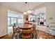 View of dining room showcasing the wooden table and chairs, with an open layout connecting to the kitchen at 4224 Firwood Ln, Charlotte, NC 28209