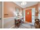 Warm entryway featuring an orange front door, a wooden console table, and stylish decor at 4224 Firwood Ln, Charlotte, NC 28209