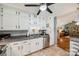 Well-lit kitchen featuring white cabinets, stainless steel appliances, and modern countertops at 4224 Firwood Ln, Charlotte, NC 28209