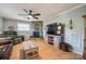Cozy living room featuring a stone fireplace, comfortable seating, and a modern entertainment setup at 4224 Firwood Ln, Charlotte, NC 28209