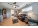 Comfortable living room with a leather sofa, wood-look floors, and ample natural light from the window at 4224 Firwood Ln, Charlotte, NC 28209