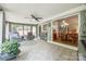 Bright sunroom with tiled flooring, ceiling fan, and connected open floor plan at 4224 Firwood Ln, Charlotte, NC 28209