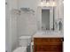 Bathroom with a wood vanity and mirror next to a toilet at 503 Walnut St, Davidson, NC 28036