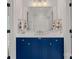 Charming bathroom vanity with blue cabinetry, white countertop, and well-lit mirror reflecting shower at 503 Walnut St, Davidson, NC 28036