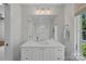 Elegant bathroom vanity with white cabinets, countertop, and a view of the glass-enclosed shower at 503 Walnut St, Davidson, NC 28036