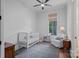 Bedroom featuring a crib and chair next to a window at 503 Walnut St, Davidson, NC 28036