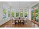Dining room with dark wood floors, large windows with diamond pattern glass and traditional chandelier at 503 Walnut St, Davidson, NC 28036