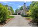 Expansive driveway leading to a well-maintained home with multiple garages and lush landscaping, enhancing curb appeal at 503 Walnut St, Davidson, NC 28036