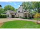 Elegant exterior showcasing a home and detached garage with meticulous landscaping and expansive driveway, highlighting its curb appeal at 503 Walnut St, Davidson, NC 28036
