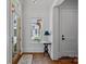 Foyer with wood door, hardwood floors, table and lamp at 503 Walnut St, Davidson, NC 28036