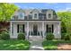 Charming two-story white brick home with a welcoming front porch and manicured lawn at 503 Walnut St, Davidson, NC 28036
