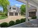 Spacious detached garage with dark wooden doors and ample parking, enhanced by charming landscape and architectural details at 503 Walnut St, Davidson, NC 28036