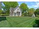 Spacious detached garage and side yard with lush lawn and architectural details, complemented by a tranquil backdrop at 503 Walnut St, Davidson, NC 28036
