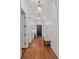 Hallway features hardwood floors, white walls, and hanging pendant lights at 503 Walnut St, Davidson, NC 28036