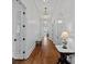 Long hallway with hardwood floors, elegant lighting fixtures, and white trim at 503 Walnut St, Davidson, NC 28036