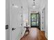 Hallway with hardwood floors, an open door and white trim at 503 Walnut St, Davidson, NC 28036