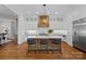 Spacious kitchen with a large island, custom cabinets, hardwood flooring, and stainless steel appliances at 503 Walnut St, Davidson, NC 28036