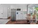 Bright kitchen area with white cabinets, stainless steel appliances, and adjoining breakfast nook at 503 Walnut St, Davidson, NC 28036
