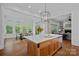 Open layout kitchen features a center island with seating, open to dining area and Gathering room at 503 Walnut St, Davidson, NC 28036