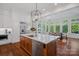 Gourmet kitchen with a center island and barstool seating, hardwood floors and stainless steel appliances at 503 Walnut St, Davidson, NC 28036