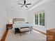 Bright main bedroom with a ceiling fan, tray ceiling, and a large window at 503 Walnut St, Davidson, NC 28036