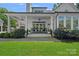 Expansive patio with seating, ceiling fans, and lush landscaping, ideal for outdoor gatherings at 503 Walnut St, Davidson, NC 28036