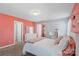 bedroom featuring a large bed with white linens and a pink accent wall with an adjacent sitting area at 5035 Terrier Ln, Fort Mill, SC 29707
