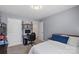 Bedroom featuring blue accent wall, neutral colored carpet, workspace, and white door at 5035 Terrier Ln, Fort Mill, SC 29707