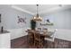 Elegant dining room featuring wainscoting, hardwood floors, and a stylish chandelier at 5035 Terrier Ln, Fort Mill, SC 29707