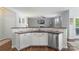 Open kitchen with stone backsplash, stainless steel dishwasher and view to the living area at 5035 Terrier Ln, Fort Mill, SC 29707