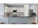 Modern kitchen featuring white cabinets, stainless steel appliances, and black countertops at 5035 Terrier Ln, Fort Mill, SC 29707