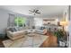 Comfortable living room flows into an open-concept kitchen and dining area with counter seating at 5035 Terrier Ln, Fort Mill, SC 29707