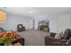Spacious living room featuring plush carpeting, comfortable leather seating, and a large entertainment center at 5035 Terrier Ln, Fort Mill, SC 29707