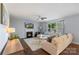 Inviting living room features a fireplace, ceiling fan, and large windows offering ample natural light at 5035 Terrier Ln, Fort Mill, SC 29707