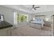 Spacious main bedroom with a tray ceiling, ceiling fan, and large window for natural light at 5035 Terrier Ln, Fort Mill, SC 29707