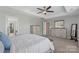 Well-lit main bedroom showcases a dresser, ceiling fan, and view into the on-suite bathroom at 5035 Terrier Ln, Fort Mill, SC 29707