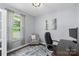 Well-lit office featuring a large window, desk, and comfortable seating area at 5035 Terrier Ln, Fort Mill, SC 29707