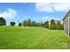 Well-maintained backyard with lush green grass and manicured landscaping at 548 Fairwoods Dr, Huntersville, NC 28078