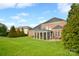 Expansive backyard with mature trees and a screened-in porch at 548 Fairwoods Dr, Huntersville, NC 28078