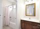 This bathroom features wood cabinets, light walls, tile flooring, and a shower and tub combo at 548 Fairwoods Dr, Huntersville, NC 28078