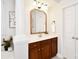 Bathroom with wood vanity and light fixture with columns and neutral paint at 548 Fairwoods Dr, Huntersville, NC 28078