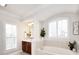 Bathroom featuring a soaking tub with tile surround, and a wood vanity with lots of light at 548 Fairwoods Dr, Huntersville, NC 28078