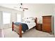 This bedroom features neutral walls, carpet, and a wood-framed bed with a blue throw at 548 Fairwoods Dr, Huntersville, NC 28078