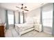 This bedroom features light-colored walls, carpet, a bed with leafy patterned bedding and two windows at 548 Fairwoods Dr, Huntersville, NC 28078