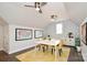 This bonus room features wood floors, two ceiling fans, wallpaper, and map wall art at 548 Fairwoods Dr, Huntersville, NC 28078