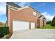 Spacious three-car garage in a beautiful red brick home at 548 Fairwoods Dr, Huntersville, NC 28078
